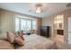 Comfortable bedroom with a large window and view into the ensuite bath and walk in closet at 2611 E San Simeon Dr, Casa Grande, AZ 85194