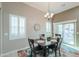 Bright dining area featuring modern lighting, neutral walls, and access to the patio at 2611 E San Simeon Dr, Casa Grande, AZ 85194