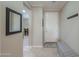 Welcoming entryway with neutral colors, tiled floors, and convenient coat hooks and seating at 2611 E San Simeon Dr, Casa Grande, AZ 85194