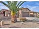 Inviting single-story home boasting a tile roof, a brown two-car garage and desert landscaping at 2611 E San Simeon Dr, Casa Grande, AZ 85194