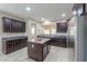 Bright kitchen showcasing dark wood cabinets, granite countertops and stainless steel appliances at 2611 E San Simeon Dr, Casa Grande, AZ 85194