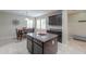 Spacious kitchen with dark wood cabinets, granite island, and a dining area with natural light at 2611 E San Simeon Dr, Casa Grande, AZ 85194
