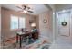 Comfortable home office with natural light, wood desk, and stylish decor at 2611 E San Simeon Dr, Casa Grande, AZ 85194