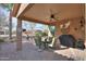 Comfortable outdoor seating under a covered patio with ceiling fan, grill and views of desert landscape at 2611 E San Simeon Dr, Casa Grande, AZ 85194