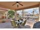 Covered patio with table and chairs, ceiling fan and lighting perfect for entertaining at 2611 E San Simeon Dr, Casa Grande, AZ 85194