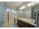 Clean shower with white tiling and glass surround, featuring double sinks at 2611 E San Simeon Dr, Casa Grande, AZ 85194