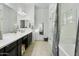 Bright bathroom featuring double sinks, a walk-in shower and a tub, and neutral decor at 26844 N 73Rd Dr, Peoria, AZ 85383