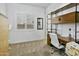 Inviting bedroom with a bright window, desk, and natural wood shelving, perfect for a home office or study at 26844 N 73Rd Dr, Peoria, AZ 85383