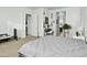 Spacious bedroom with neutral tones, carpet floors, and a view to the en-suite bathroom and study area at 26844 N 73Rd Dr, Peoria, AZ 85383