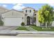 Charming home boasts a well-maintained lawn, arched entry, and attached two-car garage at 26844 N 73Rd Dr, Peoria, AZ 85383
