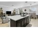 Bright, open kitchen with stainless steel appliances, a central island, and view to the living and dining areas at 26844 N 73Rd Dr, Peoria, AZ 85383