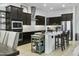 Stylish kitchen features stainless steel appliances, dark wood cabinets, and bright countertops at 26844 N 73Rd Dr, Peoria, AZ 85383