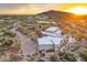 Aerial view showcasing a home in a desert setting with mature trees, a pool, and mountain views at 30600 N Pima Rd # 76, Scottsdale, AZ 85266
