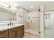 Modern bathroom featuring a walk-in shower, wooden vanity, and an illuminated mirror at 30600 N Pima Rd # 76, Scottsdale, AZ 85266