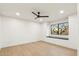 This bedroom has hardwood floors, neutral walls, recessed lighting, and a window seat with a view at 30600 N Pima Rd # 76, Scottsdale, AZ 85266