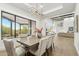 Dining area features a modern chandelier, large windows with views, and a contemporary table at 30600 N Pima Rd # 76, Scottsdale, AZ 85266