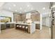 Bright kitchen features a large island with seating, modern cabinets, stainless steel appliances, and hardwood floors at 30600 N Pima Rd # 76, Scottsdale, AZ 85266