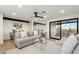 Bright living room with hardwood floors, recessed lighting, neutral furniture, and sliding door access to patio at 30600 N Pima Rd # 76, Scottsdale, AZ 85266