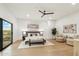 Spacious main bedroom with large windows, a ceiling fan, and comfortable seating area at 30600 N Pima Rd # 76, Scottsdale, AZ 85266