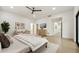 Spacious main bedroom with large windows, a ceiling fan, and comfortable seating area at 30600 N Pima Rd # 76, Scottsdale, AZ 85266