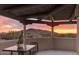 Scenic patio with mountain views at sunset, featuring an outdoor dining set and desert landscaping at 30600 N Pima Rd # 76, Scottsdale, AZ 85266