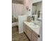 Clean bathroom with a light wood vanity, modern sink, and a shower-tub combination at 311 E Lancaster Ct, Florence, AZ 85132