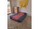 Bedroom with carpet, balcony access, dresser, and a decorative curtain, offering a simple, comfortable living space at 311 E Lancaster Ct, Florence, AZ 85132
