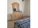 Serene bedroom featuring a wooden dresser with mirror and matching bed frame at 311 E Lancaster Ct, Florence, AZ 85132