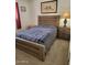 Comfortable bedroom with a wooden bed frame, matching nightstands, and natural light at 311 E Lancaster Ct, Florence, AZ 85132