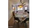Cozy dining area featuring a glass table and four chairs under a vintage-style chandelier at 311 E Lancaster Ct, Florence, AZ 85132