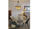 Inviting dining area with a glass-top table, unique chandelier, and comfortable seating at 311 E Lancaster Ct, Florence, AZ 85132
