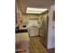 Functional kitchen with stainless steel appliances, light wood cabinetry, and laminate flooring at 311 E Lancaster Ct, Florence, AZ 85132