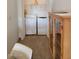 A well-lit laundry area with a washer, dryer, overhead shelving and a cabinet at 311 E Lancaster Ct, Florence, AZ 85132