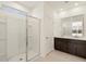 Bathroom features a glass enclosed shower and a double sink vanity with dark cabinets at 318 S San Fernando Ln, Casa Grande, AZ 85194