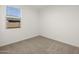 Bright carpeted bedroom featuring a window providing natural light at 318 S San Fernando Ln, Casa Grande, AZ 85194