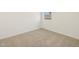Cozy carpeted bedroom with a small window and neutral decor at 318 S San Fernando Ln, Casa Grande, AZ 85194