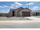 Inviting single-level home features a well-kept front yard and a spacious two-car garage at 318 S San Fernando Ln, Casa Grande, AZ 85194