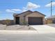 Charming single-story home with a desert-landscaped front yard and a two-car garage at 318 S San Fernando Ln, Casa Grande, AZ 85194