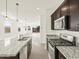 The kitchen features stainless steel appliances, granite counters, and dark wood cabinets at 318 S San Fernando Ln, Casa Grande, AZ 85194