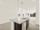 Bright kitchen boasts granite counters, stainless appliances, and modern pendant lighting at 318 S San Fernando Ln, Casa Grande, AZ 85194