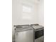 The laundry room features modern washer and dryer units with a window for natural light at 318 S San Fernando Ln, Casa Grande, AZ 85194