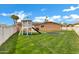 Spacious backyard with lush green grass, a playground, and mature trees at 3222 W Hearn Rd, Phoenix, AZ 85053