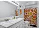 Bright bathroom with a double vanity and a colorful shower curtain at 3222 W Hearn Rd, Phoenix, AZ 85053