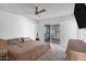 A cozy bedroom with a ceiling fan and sliding glass doors to the outside at 3222 W Hearn Rd, Phoenix, AZ 85053