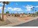Charming single-story home featuring a desert landscape, solar panels and a circular driveway at 3222 W Hearn Rd, Phoenix, AZ 85053
