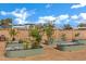 Lovely raised garden beds set in a yard with a block fence and mature trees at 3222 W Hearn Rd, Phoenix, AZ 85053
