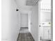 A well-lit hallway with tile floor leading to a bathroom at 3222 W Hearn Rd, Phoenix, AZ 85053