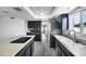 Spacious eat-in kitchen featuring dark cabinets and a view through to another living space at 3222 W Hearn Rd, Phoenix, AZ 85053