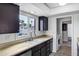 A charming kitchen with dark cabinets, light countertops, and a window view to the backyard at 3222 W Hearn Rd, Phoenix, AZ 85053