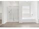 This bathroom features a glass enclosed shower and a soaking tub by a window at 345 S Alegria Ln, Casa Grande, AZ 85194